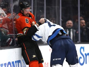 The Ducks’ Erik Gudbranson (left) gets into a fight with Winnipeg Jets’ Anthony Bitetto at Honda Center in Anaheim, Calif., last night. (Getty Images)
