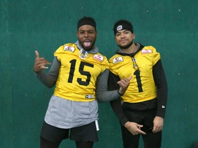 Hamilton Tiger-Cats’ Marcus Tucker (left) and Anthony Coombs play to the camera during the leadup to Sunday’s Grey Cup game in Calgary. Coombs is a Winnipegger and University of Manitoba product. (JIM WELLS/POSTMEDIA NETWORK)