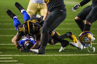 Nov 24, 2019; Calgary, Alberta, CAN; Winnipeg Blue Bombers wide receiver Nic Demski (10) tackled by Hamilton Tiger-Cats defensive back Cariel Brooks (26) in the second half during the 107th Grey Cup championship football game at McMahon Stadium. Mandatory Credit: Sergei Belski-USA TODAY Sports