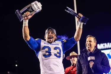 Nov 24, 2019; Calgary, Alberta, CAN; Winnipeg Blue Bombers running back Andrew Harris (33) lifts trophies after the game against the Hamilton Tiger-Cats during the 107th Grey Cup championship football game at McMahon Stadium. Mandatory Credit: Sergei Belski-USA TODAY Sports