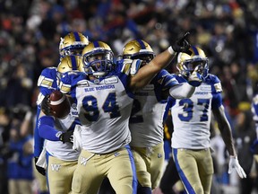 Winnipeg Blue Bombers defensive end Jackson Jeffcoat (94) reacts with teammates after recovering a Hamilton Tiger-Cats fumble in the second half during the 107th Grey Cup championship football game at McMahon Stadium.