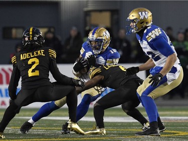 Nov 24, 2019; Calgary, Alberta, CAN; Winnipeg Blue Bombers wide receiver Nic Demski (10) runs the ball tackled by Hamilton Tiger-Cats quarterback David Watford (6) in the first half during the 107th Grey Cup championship football game at McMahon Stadium. Mandatory Credit: Eric Bolte-USA TODAY Sports