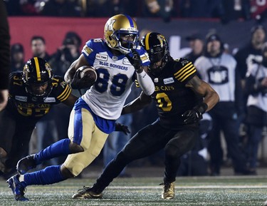 Nov 24, 2019; Calgary, Alberta, CAN; Winnipeg Blue Bombers wide receiver Rasheed Bailey (88) runs with the ball after a catch as Hamilton Tiger-Cats defensive back Frankie Williams (37) defends with defensive back Rico Murray (0) in the first half during the 107th Grey Cup championship football game at McMahon Stadium. Mandatory Credit: Eric Bolte-USA TODAY Sports