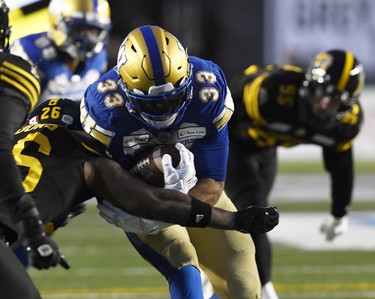 Nov 24, 2019; Calgary, Alberta, CAN; Winnipeg Blue Bombers running back Andrew Harris (33) scores a touchdown against the Hamilton Tiger-Cats in the first half during the 107th Grey Cup championship football game at McMahon Stadium. Mandatory Credit: Eric Bolte-USA TODAY Sports