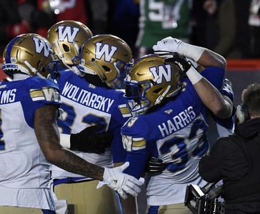 Nov 24, 2019; Calgary, Alberta, CAN; Winnipeg Blue Bombers running back Andrew Harris (33) celebrates with teammates after scoring a touchdown against the Hamilton Tiger-Cats in the first half during the 107th Grey Cup championship football game at McMahon Stadium. Mandatory Credit: Eric Bolte-USA TODAY Sports