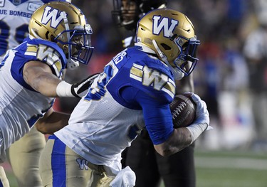 Nov 24, 2019; Calgary, Alberta, CAN; Winnipeg Blue Bombers running back Andrew Harris (33) celebrates with teammates after scoring a touchdown against the Hamilton Tiger-Cats in the first half during the 107th Grey Cup championship football game at McMahon Stadium. Mandatory Credit: Eric Bolte-USA TODAY Sports