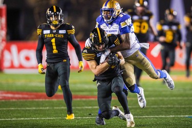 Nov 24, 2019; Calgary, Alberta, CAN; Hamilton Tiger-Cats wide receiver Jaelon Acklin (80) tackled by Winnipeg Blue Bombers defensive back Brandon Alexander (37) in the second half during the 107th Grey Cup championship football game at McMahon Stadium. Mandatory Credit: Sergei Belski-USA TODAY Sports