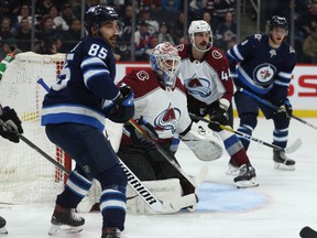 From left: Jets’ Mathieu Perrault, Avalanche goaltender Adam Werner, Avs’ Mark Barberio and Jets’ Andrew Copp follow the play during Tuesday night’s game at Bell MTS Place in Winnipeg. Werner replaced Pavel Francouz, who left injured. (KEVIN KING/WINNIPEG SUN)