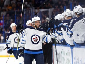 Winnipeg Jets center Mathieu Perreault (85) is congratulated as he scores a goal against the Tampa Bay Lightning during the first period at Amalie Arena on Nov 16, 2019 in Tampa, Fla. Perreault returns to the Jets lineup tonight. Kim Klement-USA TODAY Sports file