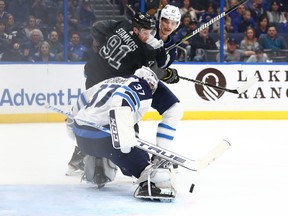 Nov 16, 2019; Tampa, FL, USA; Winnipeg Jets goaltender Connor Hellebuyck (37) makes a save against the Tampa Bay Lightning during the first period at Amalie Arena. Mandatory Credit: Kim Klement-USA TODAY Sports