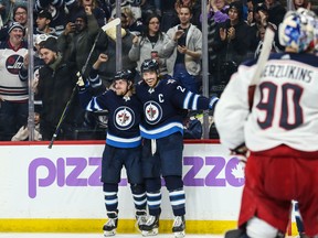 Jets’ Nikolaj Ehlers (left) and Blake Wheeler celebrate after Ehlers’ goal in the second periood of Saturday night’s game against the Columbus Blue Jackets in Winnipeg. (USA TODAY SPORTS)