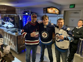 Clay Cawthon, middle, with a couple of Winnipeggers he met at Tuesday's game in Nashville. The Jets won 2-1.