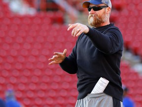 Blue Bombers head coach 
Mike O’Shea tosses the ball during practice at McMahon stadium 
in Calgary yesterday. 
(Darren Makowichuk/Postmedia network)