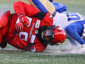 Blue Bombers’ Winston Rose (right) breaks up a pass intended for Kamar Jorden during the West Division semifinal in Calgary last Sunday. Rose signed as a free agent with the Bombers in February and has no regrets. (AL CHAREST/POSTMEDIA NETWORK)