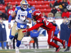 Calgary Stampeders, Jamar Wall tries to tackle Winnipeg Blue Bombers QB, Chris Streveler during the CFL semi-finals in Calgary on Sunday, November 10, 2019. Darren Makowichuk/Postmedia