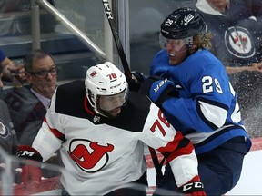 Jets forward Patrik Laine (right) takes a run at New Jersey Devils defenceman P.K. Subban in Winnipeg on Tues., Nov. 5, 2019. (KEVIN KING/WINNIPEG SUN)