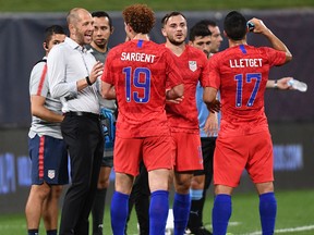 In this Sept. 10, 2019, file photo, United States' head coach Gregg Berhalter (L) gives instructions to United States' forward Josh Sargent during the International Friendly football match between the United States and Uruguay at Busch Stadium, in St. Louis, Mo.