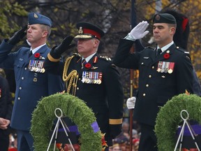 Gen. Jonathan Vance, Chief of the Defence Staff, centre, salutes during Remembrance Day ceremonies at the National War Memorial in Ottawa on Friday, Nov. 11, 2016. (Patrick Doyle)