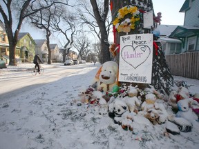 Fresh snow covers a large pile of cards and stuffed animals at the base of a tree in front of the Winnipeg home on Nov. 3, 2019, where three-year-old Hunter Haze Straight-Smith was stabbed while he slept. The murder trial jury is expected to hear closing arguments today.