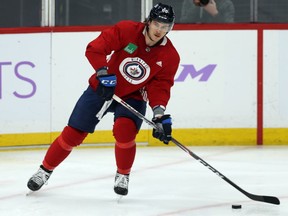 Nathan Beaulieu moves the puck during Winnipeg Jets practice at Bell MTS Place on Monday.