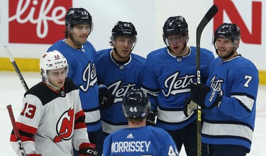 Winnipeg Jets centre Andrew Copp (second from right) celebrates his second-period goal against the New Jersey Devils in Winnipeg with Adam Lowry, Gabriel Bourque, Josh Morrissey and Dmitry Kulikov (from left) on Tues., Nov. 5, 2019. Kevin King/Winnipeg Sun/Postmedia Network