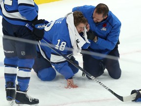 Winnipeg Jets centre Bryan Little holds a towel to his head where he was hit with a shot from a teammate during NHL action against the New Jersey Devils in Winnipeg on Tues., Nov. 5, 2019. Kevin King/Winnipeg Sun/Postmedia Network