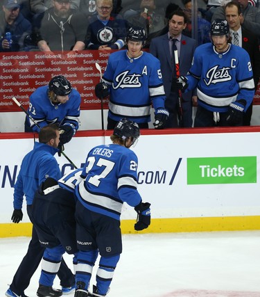 The Winnipeg Jets bench looks on in concern as centre Bryan Little comes off the ice after taking a puck to the head against the New Jersey Devils in Winnipeg on Tues., Nov. 5, 2019. Kevin King/Winnipeg Sun/Postmedia Network