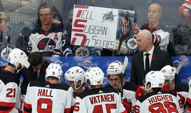 A Winnipeg Jets fan holds a sign behind the New Jersey Devils bench during a timeout in Winnipeg on Tues., Nov. 5, 2019. Kevin King/Winnipeg Sun/Postmedia Network