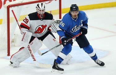 Winnipeg Jets forward Blake Wheeler (right) sets up in front of New Jersey Devils goaltender Mackenzie Blackwood in Winnipeg on Tues., Nov. 5, 2019. Kevin King/Winnipeg Sun/Postmedia Network