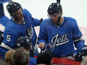 Winnipeg Jets defenceman Anthony Bitetto (right) makes a point to Nathan Beaulieu (seated) with Luca Sbisa chiming in during a break in action against the New Jersey Devils in Winnipeg on Tues., Nov. 5, 2019. Kevin King/Winnipeg Sun/Postmedia Network