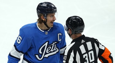 Winnipeg Jets captain Blake Wheeler disputes a point with referee Kendrick Nicholson during a break in action against the New Jersey Devils in Winnipeg on Tues., Nov. 5, 2019. Kevin King/Winnipeg Sun/Postmedia Network