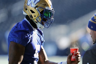 Defensive end Willie Jefferson warms his hands with a cup of coffee during Winnipeg Blue Bombers practice on Wed., Nov. 6, 2019. Kevin King/Winnipeg Sun/Postmedia Network