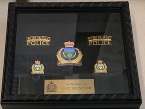 Photo of the shadow box containing a Winnipeg Police Service badge and certificate presented by the Winnipeg Police Service to the family of Hunter Haze Straight-Smith at the three-year-old's wake service on Friday evening.