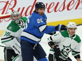 Winnipeg Jets centre Blake Wheeler (centre) sets up in front of Dallas Stars goaltender Anton Khudobin and behind defenceman Andrej Sekera in Winnipeg on Sun., Nov. 10, 2019. Kevin King/Winnipeg Sun/Postmedia Network