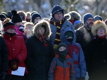 People try to stay warm during the Royal Winnipeg Rifles Association Remembrance Day Service at Vimy Memorial Park in Winnipeg on Mon., Nov. 11, 2019. Kevin King/Winnipeg Sun/Postmedia Network