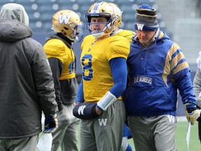 Quarterback Zach Collaros (centre) works with offensive co-ordinator Paul LaPolice (right) during Winnipeg Blue Bombers practice in Winnipeg on Wednesday, Nov. 13, 2019.