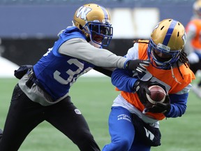 Mercy Maston (left) grabs receiver Janarion Grant during Winnipeg Blue Bombers practice in Winnipeg on Wed., Nov. 13, 2019. Kevin King/Winnipeg Sun/Postmedia Network