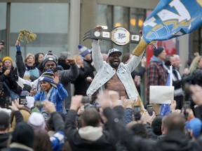 Bombers players and fans celebrate during the Grey Cup parade trough downtown Winnipeg on Tuesday.