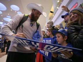 Winnipeg Blue Bombers quarterback Chris Streveler (left) signs an autograph for a young fan at Winnipeg James Armstrong Richardson International Airport on Mon., Nov. 25, 2019 after the team returned from Calgary with the Grey Cup. Kevin King/Winnipeg Sun/Postmedia Network