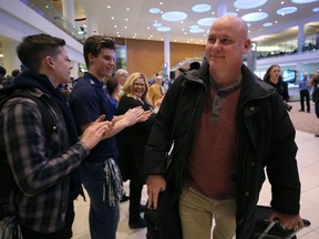 Winnipeg Blue Bombers offensive co-ordinator Paul LaPolice is applauded at Winnipeg James Armstrong Richardson International Airport on Monday after the team came home from Calgary with the Grey Cup.