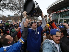 Winnipeg Blue Bombers offensive lineman Pat Neufeld brings the Grey Cup into the Forks after the parade on Tuesday, Nov. 26.