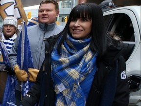 Dayna Spiring, chair of the Winnipeg Blue Bombers Football Club, waits for the start of the Grey Cup parade on Tuesday. Spiring will be the first woman with her name on the trophy.