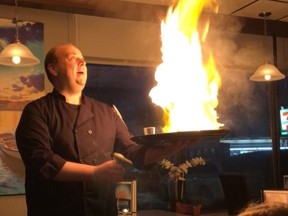 Nick Douklias prepares a fried cheese dish call Saganaki at Helios Restaurant at 241-St. Mary's Road in Winnipeg. Even better than the show, is the yummy Kefalograviera cheese lightly battered and flambeed in a pan in a seven year old Cognac and served with warm pita bread.