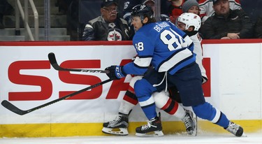 Winnipeg Jets defenceman Nathan Beaulieu (left) rubs out New Jersey Devils forward Taylor Hall in Winnipeg on Tues., Nov. 5, 2019. Beaulieu was penalized for interference. Kevin King/Winnipeg Sun/Postmedia Network