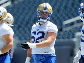 Offensive lineman Cody Speller (centre) chats with Stanley Bryant during Winnipeg Blue Bombers practice Kevin King/Winnipeg Sun/Postmedia Network