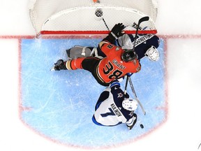 ANAHEIM, CALIFORNIA - NOVEMBER 29:  Derek Grant #38 of the Anaheim Ducks splits the defense of Dmitry Kulikov #7 and Connor Hellebuyck #37 of the Winnipeg Jets defend during the second period of a game at Honda Center on November 29, 2019 in Anaheim, California. (Photo by Sean M. Haffey/Getty Images)