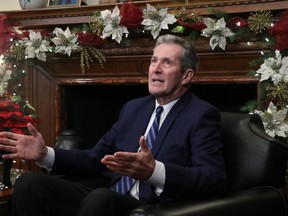 Manitoba Premier Brian Pallister fields questions during his year-end scrum with the media at the Manitoba Legislature in Winnipeg on Tuesday.