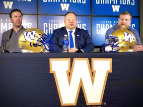 The Winnipeg Blue Bombers announced new deals for their general manager Kyle Walters (left) and head coach Mike OÕShea (right) who flank CEO Wade Miller during a press conference Friday.