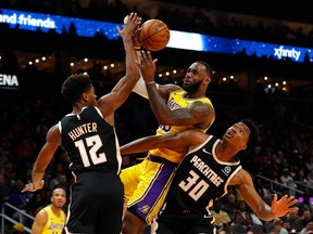 Los Angeles Lakers' LeBron James drives against De'Andre Hunter and Damian Jones of the Atlanta Hawks this week. (GETTY IMAGES)