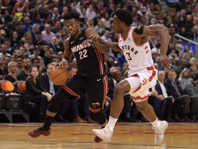 Miami Heat forward Jimmy Butler, left, dribbles the ball as Toronto Raptors forward OG Anunoby defends in the first half at Scotiabank Arena, Dec. 3, 2019. (Dan Hamilton-USA TODAY Sports)
